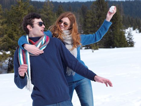 romantic winter  scene, happy young couple having fun on fresh show on winter vacatio, mountain nature landscape