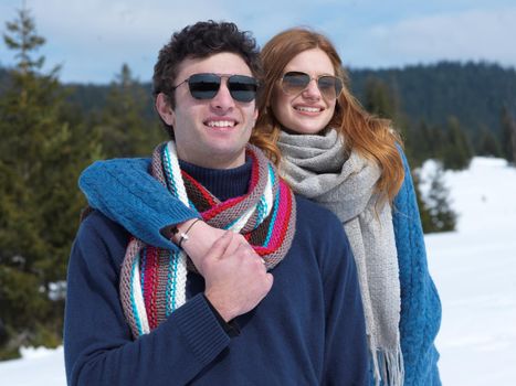 romantic winter  scene, happy young couple having fun on fresh show on winter vacatio, mountain nature landscape