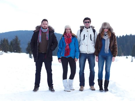 group of friends have fun and relaxing on winter vacation on beautiful sunny day with fresh snow