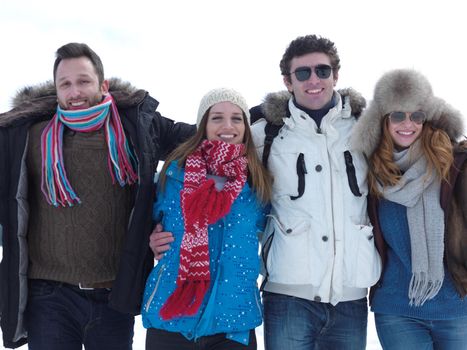 group of friends have fun and relaxing on winter vacation on beautiful sunny day with fresh snow