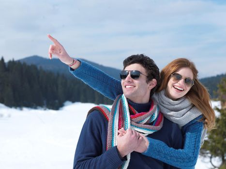 romantic winter  scene, happy young couple having fun on fresh show on winter vacatio, mountain nature landscape