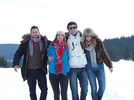 group of friends have fun and relaxing on winter vacation on beautiful sunny day with fresh snow