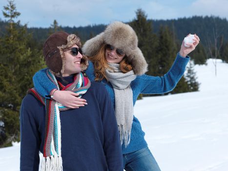 romantic winter  scene, happy young couple having fun on fresh show on winter vacatio, mountain nature landscape