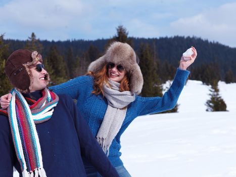 romantic winter  scene, happy young couple having fun on fresh show on winter vacatio, mountain nature landscape