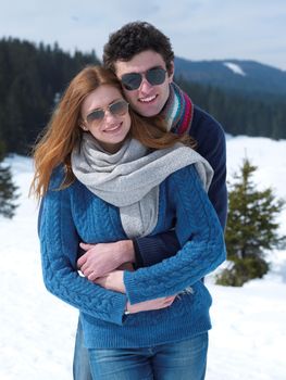 romantic winter  scene, happy young couple having fun on fresh show on winter vacatio, mountain nature landscape