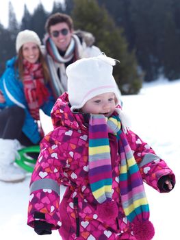 Winter playing, fun, snow and family portrait  sledding at winter time