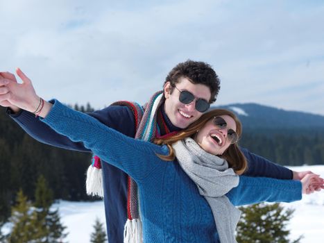 romantic winter  scene, happy young couple having fun on fresh show on winter vacatio, mountain nature landscape