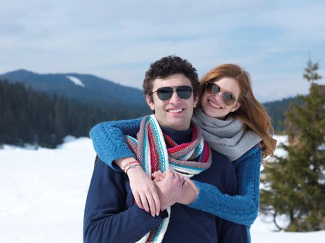 romantic winter  scene, happy young couple having fun on fresh show on winter vacatio, mountain nature landscape