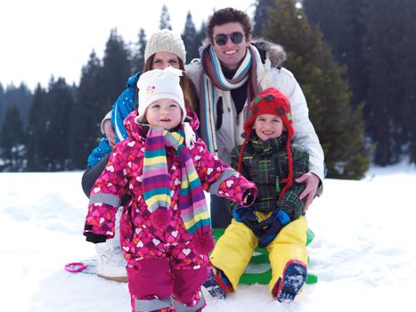 Winter playing, fun, snow and family portrait  sledding at winter time