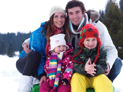 Winter playing, fun, snow and family portrait  sledding at winter time