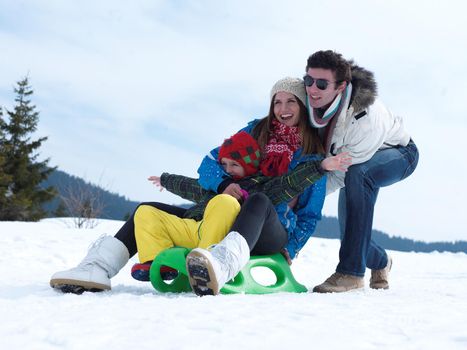 Winter playing, fun, snow and family portrait  sledding at winter time