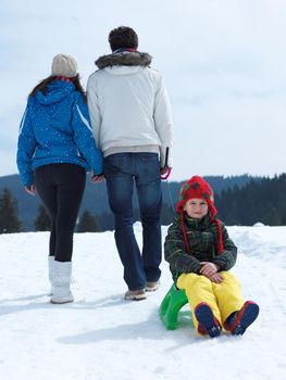 Winter playing, fun, snow and family portrait  sledding at winter time