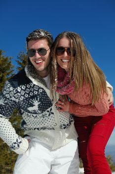 Young Couple In winter Snow Scene at  beautiful sunny day