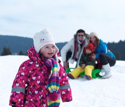 Winter playing, fun, snow and family portrait  sledding at winter time