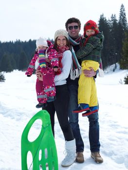 Winter playing, fun, snow and family portrait  sledding at winter time