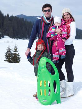 Winter playing, fun, snow and family portrait  sledding at winter time