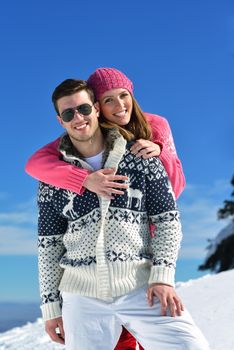 Young Couple In winter Snow Scene at  beautiful sunny day