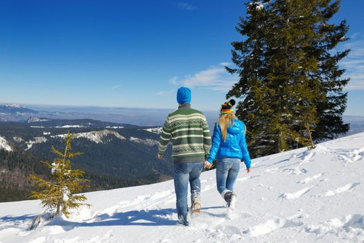 Young Couple In winter Snow Scene at  beautiful sunny day