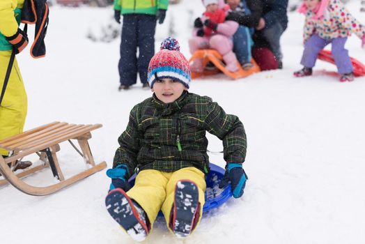 portrait of happy smiling little boy child outdoors having fun and playing on snowy winter day