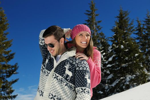 Young Couple In winter Snow Scene at  beautiful sunny day