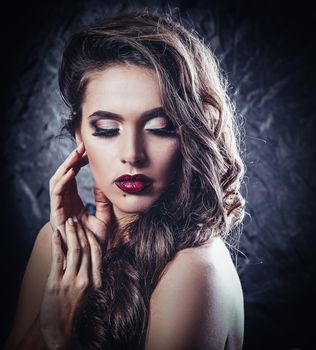 glamorous young woman with evening makeup. isolated on black background