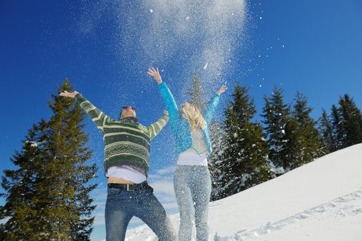 Young Couple In winter Snow Scene at  beautiful sunny day