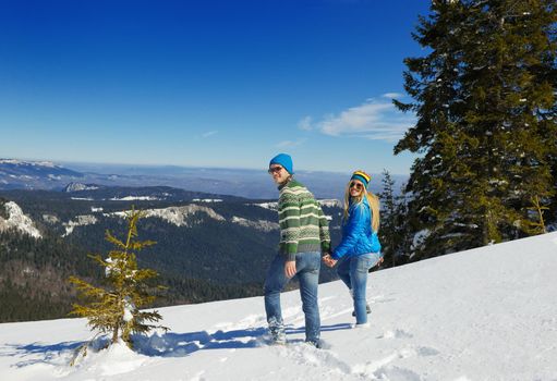 Young Couple In winter Snow Scene at  beautiful sunny day