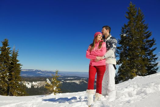 Young Couple In winter Snow Scene at  beautiful sunny day