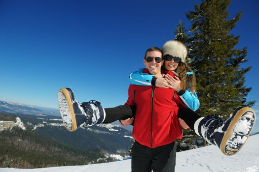 Young Couple In winter Snow Scene at  beautiful sunny day