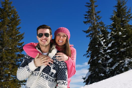 Young Couple In winter Snow Scene at  beautiful sunny day