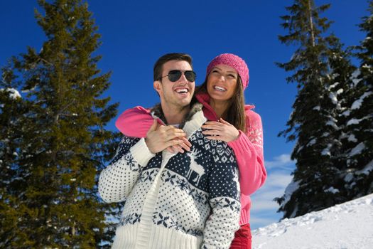 Young Couple In winter Snow Scene at  beautiful sunny day