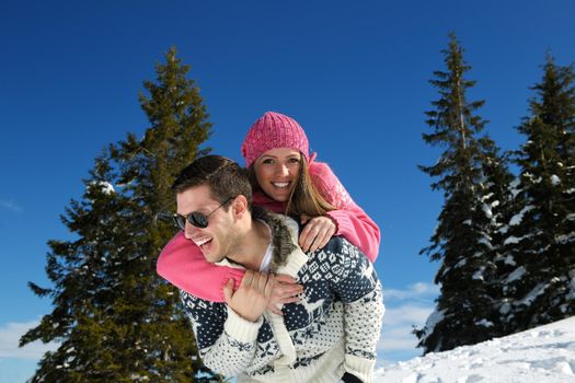 Young Couple In winter Snow Scene at  beautiful sunny day