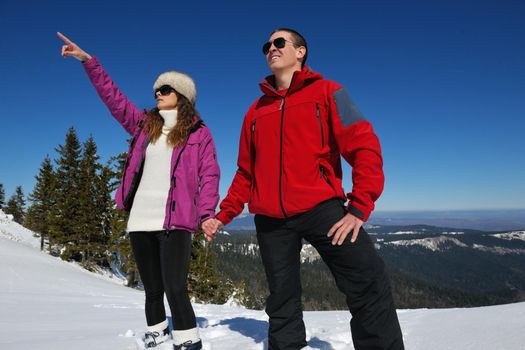 Young Couple In winter Snow Scene at  beautiful sunny day