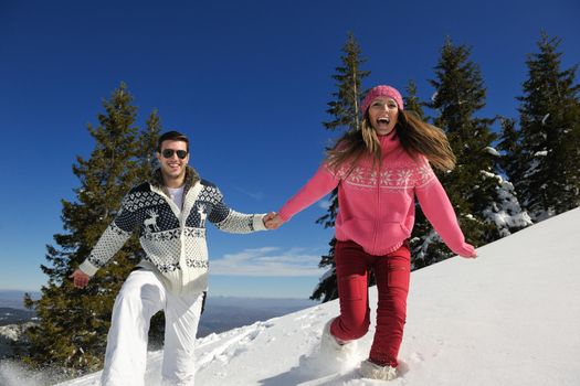 Young Couple In winter Snow Scene at  beautiful sunny day