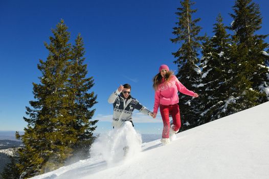 Young Couple In winter Snow Scene at  beautiful sunny day