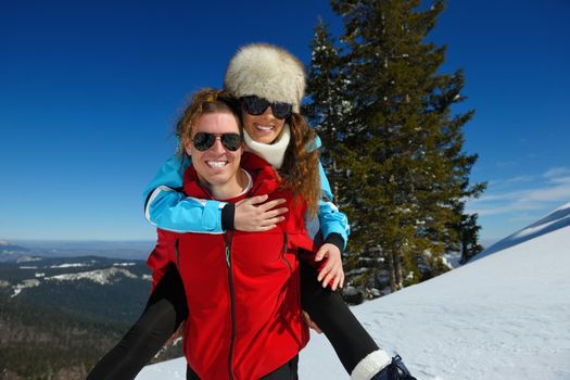 Young Couple In winter Snow Scene at  beautiful sunny day