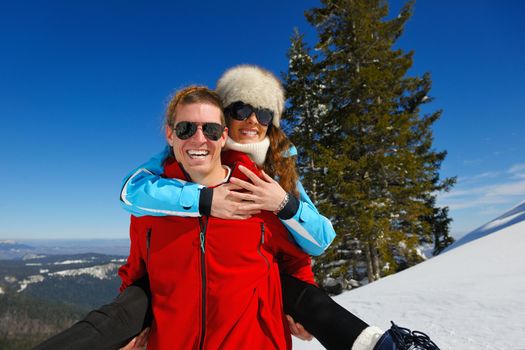 Young Couple In winter Snow Scene at  beautiful sunny day