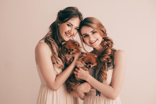 two cute girls with their lovely Pets . wedding for dogs