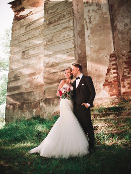 portrait of a happy couple in love on the background of an old manor . bride and groom