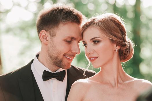 beautiful couple of newlyweds on the background of the spring Park. bride and groom