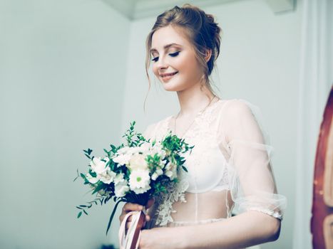portrait of a pretty young bride with a wedding bouquet. holidays and events