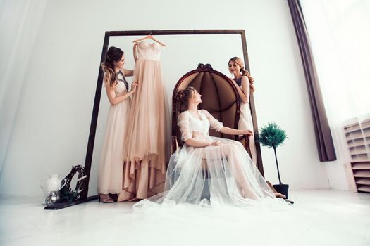 bride with her friends discussing the wedding dress. photo with copy space