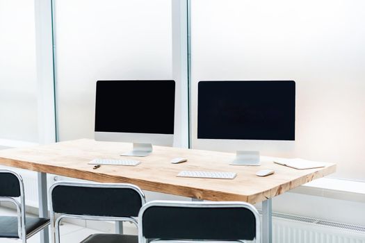 personal computers on a Desk in an empty office. photo with copy space