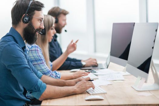 close up. call center employees work on PC in the office