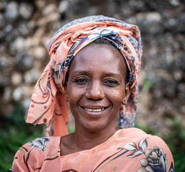 Black African senior beautiful woman with scarf outdoors