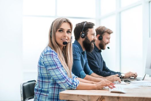 young woman with colleagues working in the office of the call center. photo with copy space