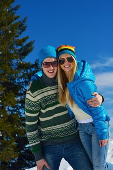 Young Couple In winter Snow Scene at  beautiful sunny day