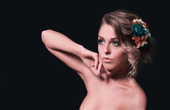 beautiful attractive girl with flowers in her hair. Posing for the camera.