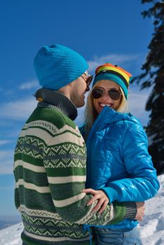 Young Couple In winter Snow Scene at  beautiful sunny day