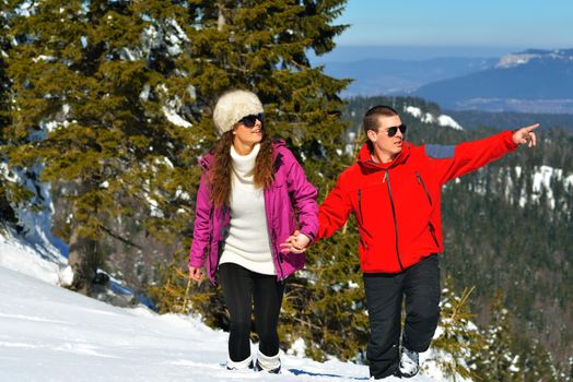 Young Couple In winter Snow Scene at  beautiful sunny day